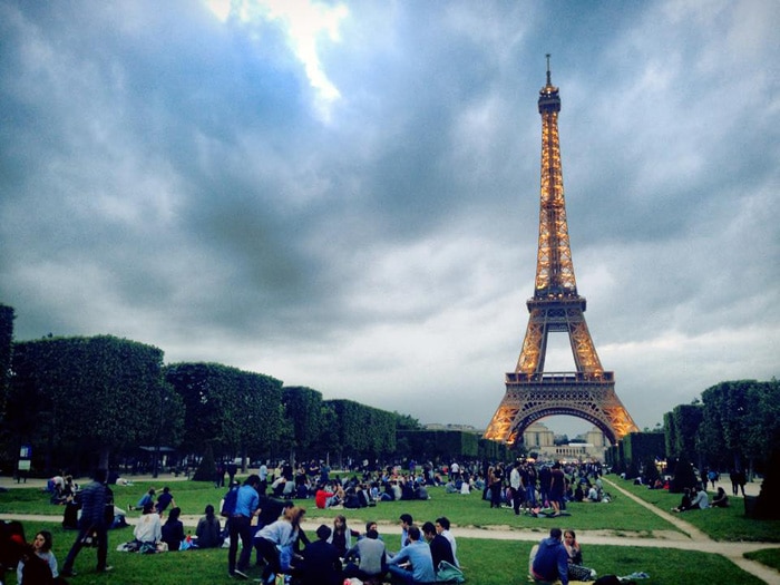 Hanging out with friends in the glow of the Eiffel Tower.