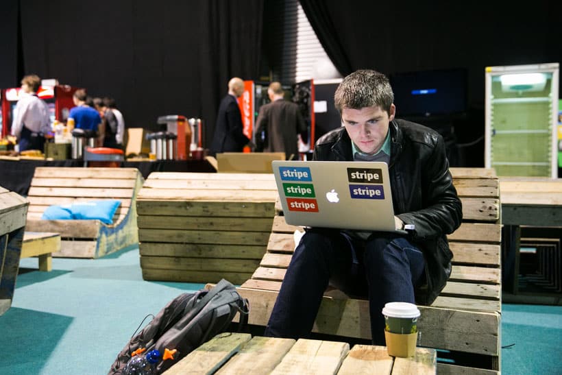 John Collison, co-founder of Stripe, working at a laptop